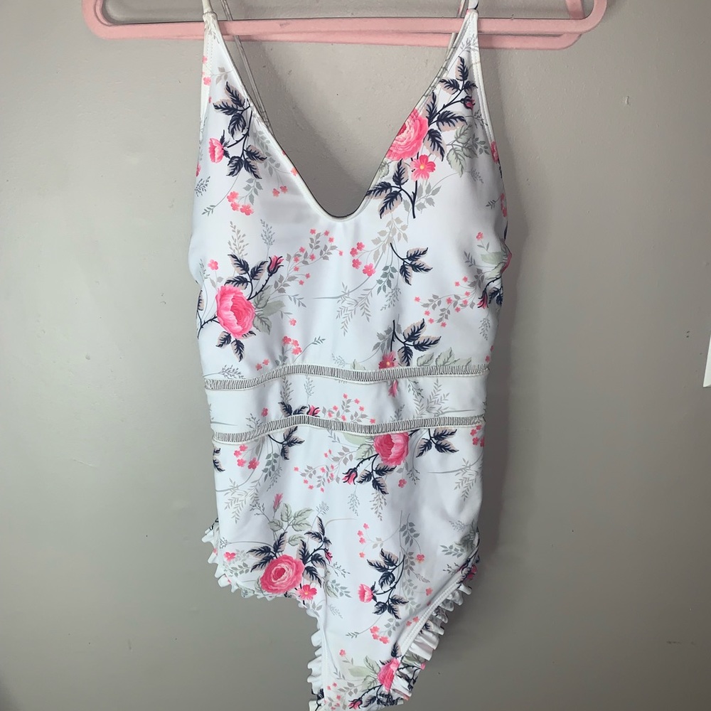 Size 2Xl one piece bathing suit with ruffles butt cheeks and cross back.